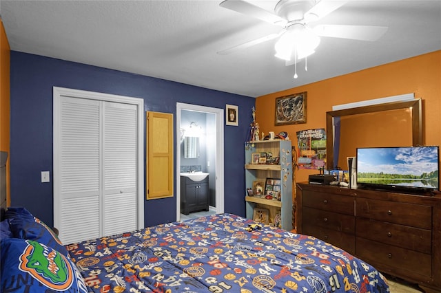 bedroom with sink, connected bathroom, ceiling fan, and a closet