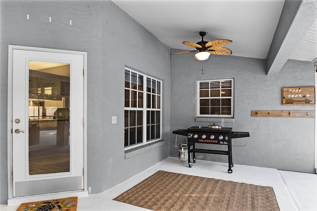 interior space with ceiling fan and a patio area