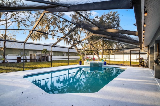 view of pool with a yard, a patio area, and glass enclosure