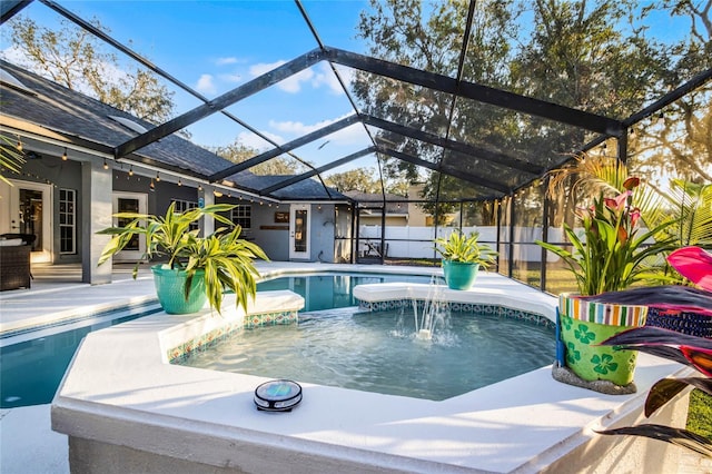 view of pool featuring a patio, pool water feature, and glass enclosure