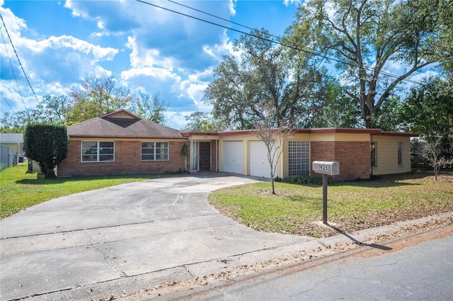 single story home with a garage and a front lawn