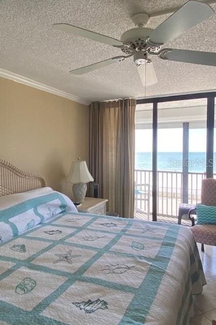 bedroom with crown molding, a water view, expansive windows, a textured ceiling, and access to outside