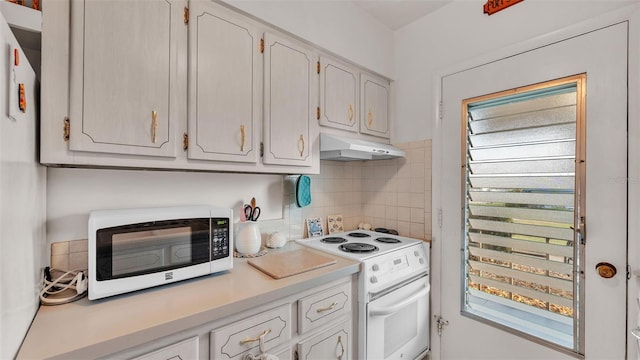 kitchen featuring white cabinetry, backsplash, and white appliances