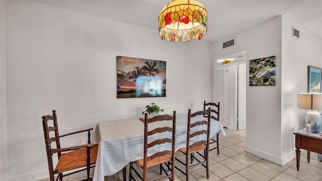 dining space featuring light tile patterned floors