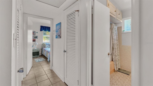 hallway featuring light tile patterned floors