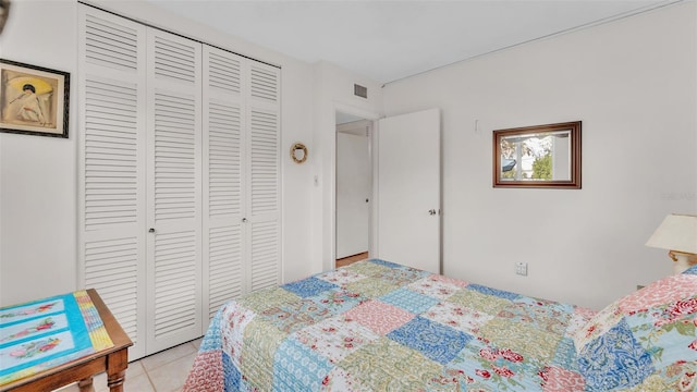 tiled bedroom featuring a closet