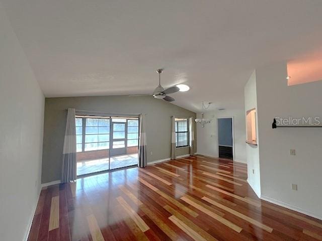 empty room featuring ceiling fan, wood-type flooring, and vaulted ceiling