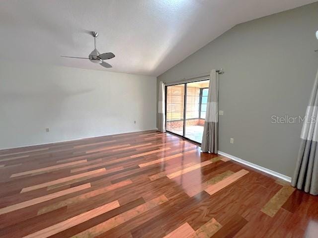 spare room featuring lofted ceiling, dark hardwood / wood-style flooring, and ceiling fan