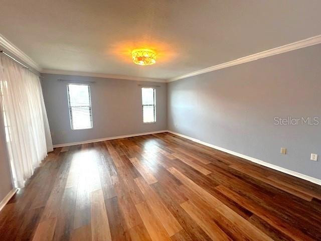 unfurnished room featuring hardwood / wood-style flooring and ornamental molding