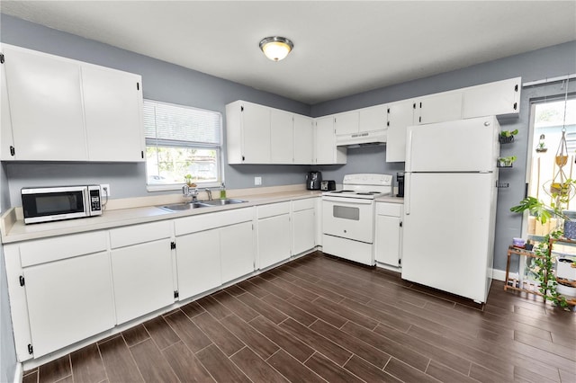 kitchen with sink, white appliances, and white cabinets