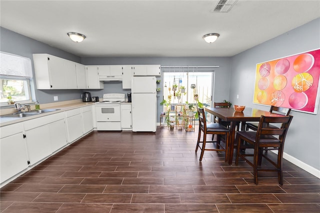 kitchen with white cabinetry, sink, and white appliances