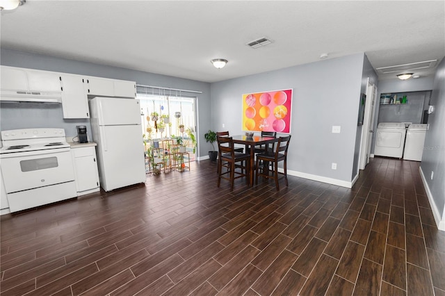 kitchen with white cabinetry, white appliances, separate washer and dryer, and dark hardwood / wood-style floors