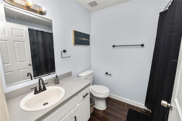 bathroom featuring vanity and toilet