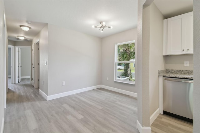 unfurnished dining area with light wood-type flooring