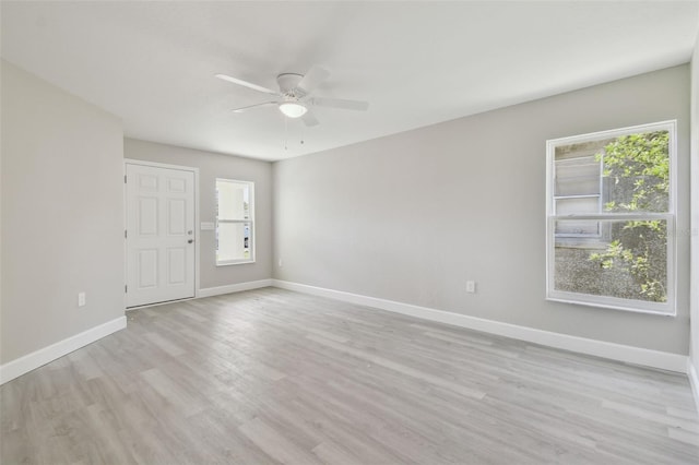 empty room with ceiling fan and light hardwood / wood-style floors