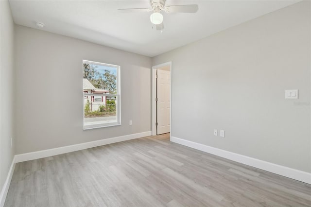 spare room featuring ceiling fan and light hardwood / wood-style floors