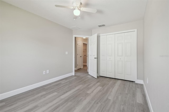 unfurnished bedroom featuring light hardwood / wood-style floors, a closet, and ceiling fan