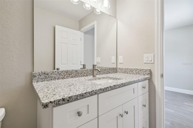 bathroom featuring vanity and hardwood / wood-style flooring