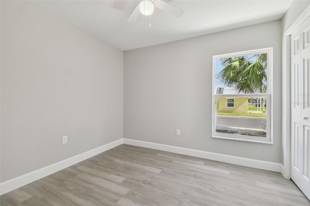 unfurnished room with ceiling fan and light wood-type flooring