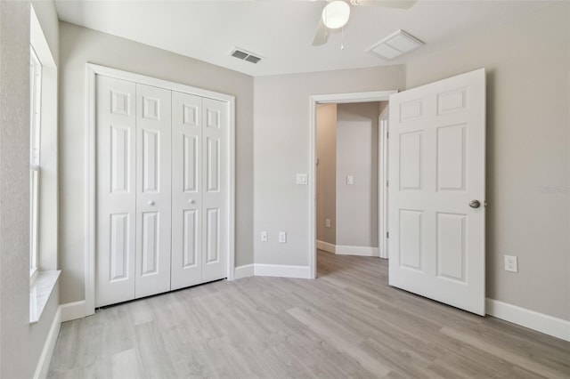 unfurnished bedroom with ceiling fan, a closet, and light wood-type flooring