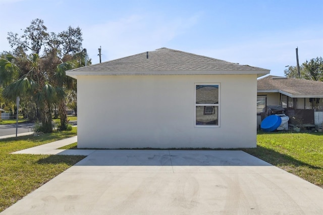 view of property exterior featuring a lawn