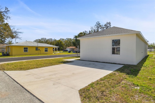 view of property exterior with a yard