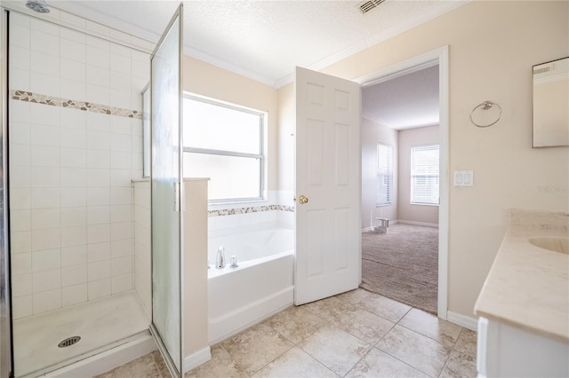 bathroom featuring plus walk in shower, vanity, ornamental molding, tile patterned floors, and a textured ceiling