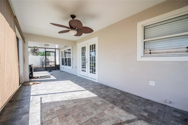 unfurnished sunroom featuring french doors and ceiling fan