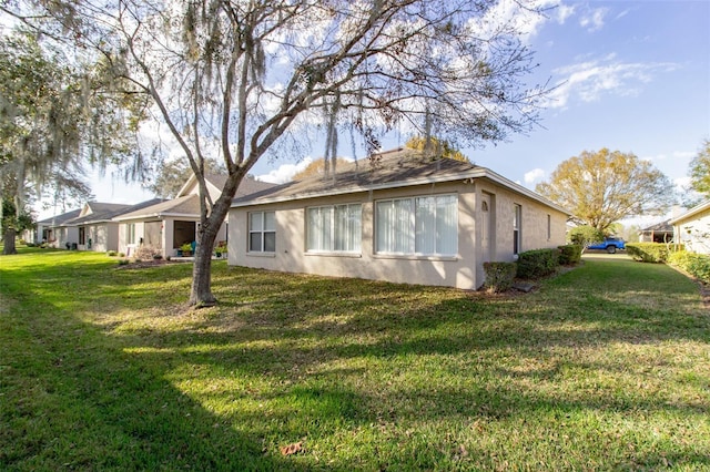 view of side of property with a yard