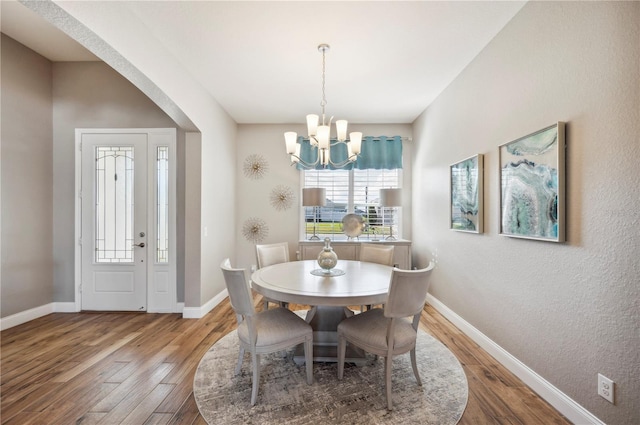 dining area featuring a chandelier and hardwood / wood-style floors