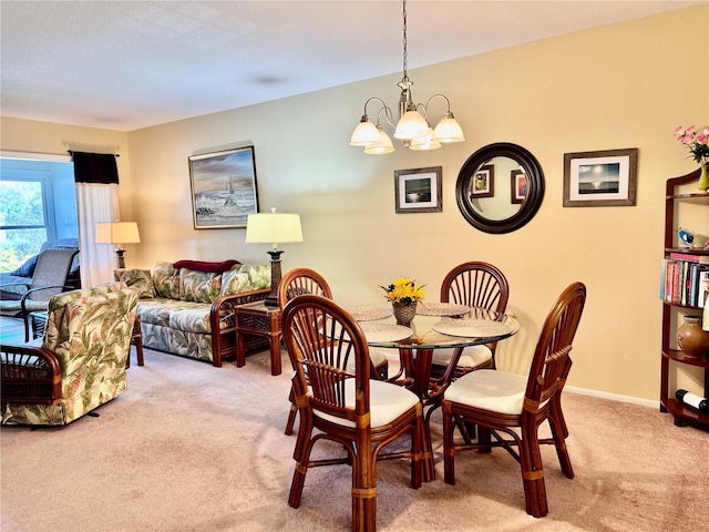 dining space with light carpet and a notable chandelier