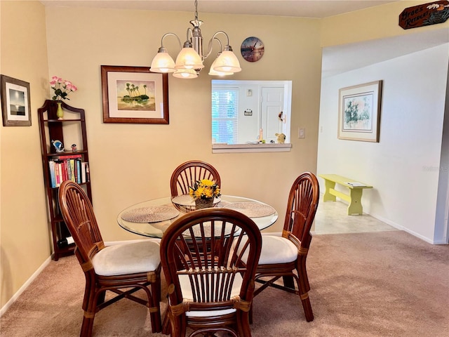 carpeted dining room featuring a chandelier