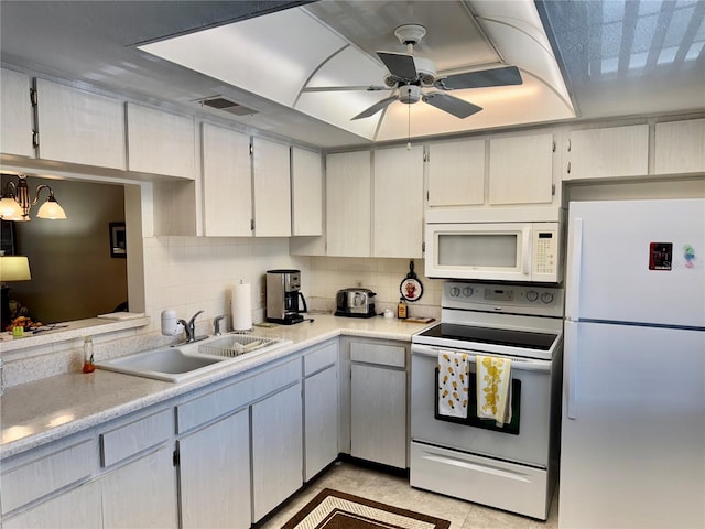 kitchen with ceiling fan, sink, white appliances, and decorative backsplash