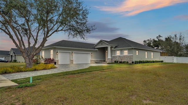 view of front facade with a garage and a lawn