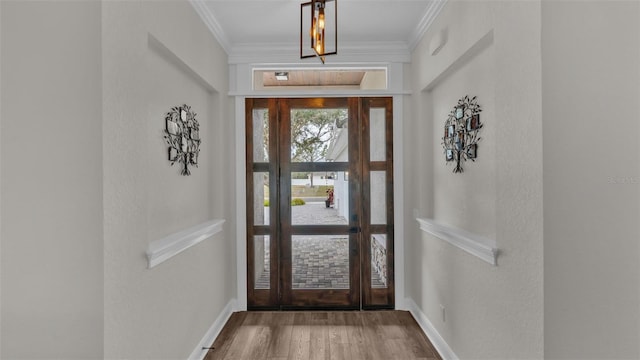 foyer entrance featuring crown molding and hardwood / wood-style flooring