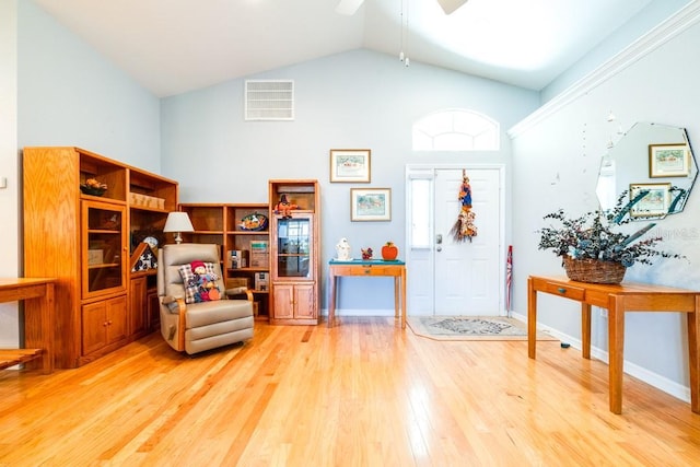 foyer with ceiling fan, high vaulted ceiling, and hardwood / wood-style floors