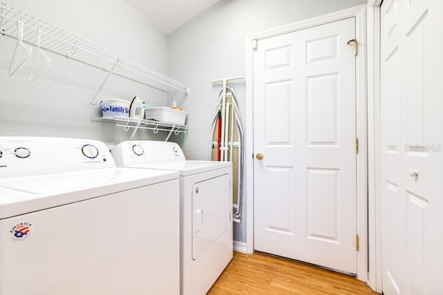 washroom featuring washing machine and clothes dryer and light wood-type flooring