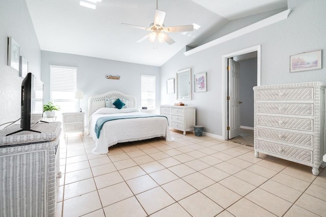 tiled bedroom with ceiling fan and lofted ceiling