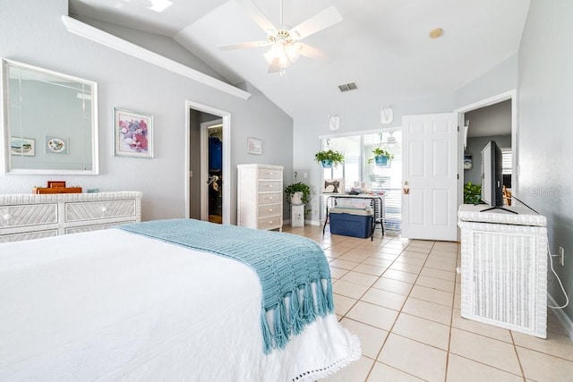 tiled bedroom with ceiling fan and lofted ceiling