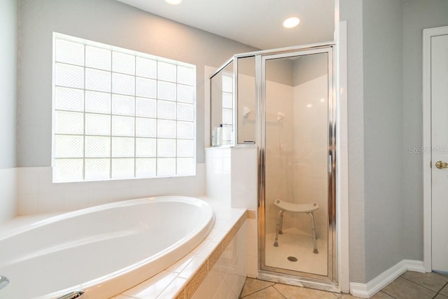 bathroom with plus walk in shower and tile patterned flooring