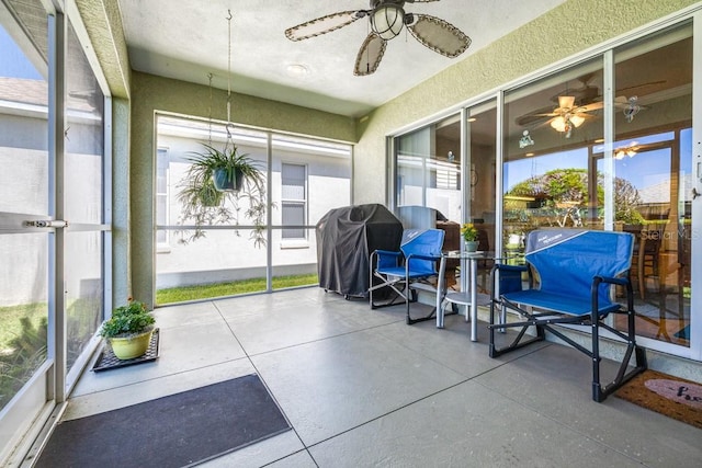 sunroom featuring ceiling fan