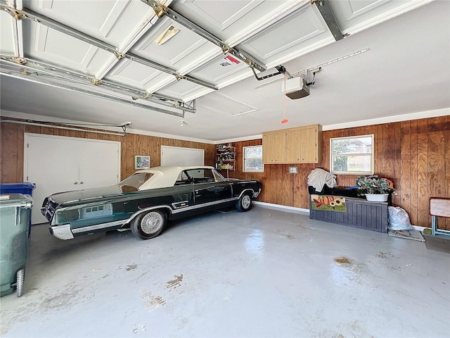 garage with a garage door opener and wooden walls