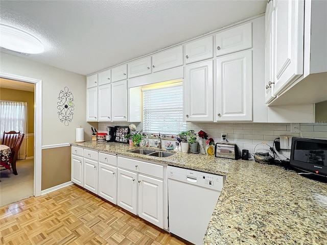 kitchen featuring white cabinetry, sink, and dishwasher