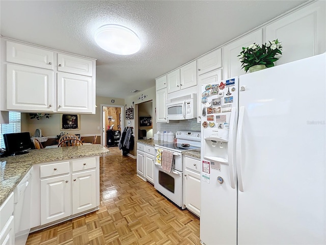 kitchen featuring white cabinetry, white appliances, and light parquet floors