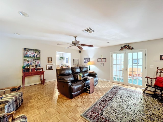 living room with french doors, ceiling fan, and light parquet floors