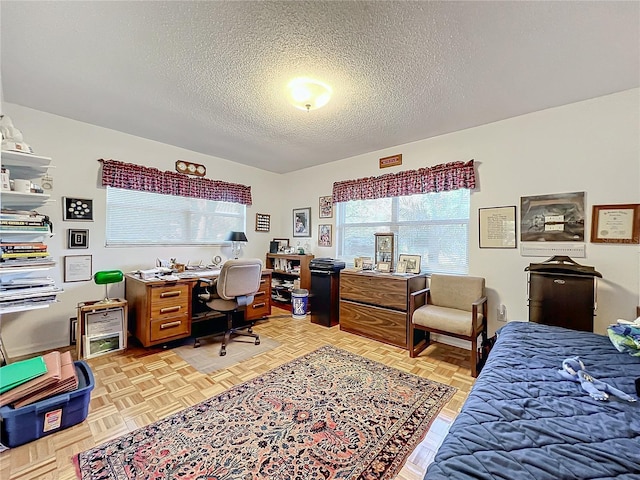 bedroom with light parquet flooring and a textured ceiling