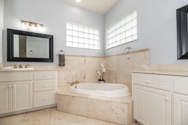 bathroom featuring a garden tub and vanity