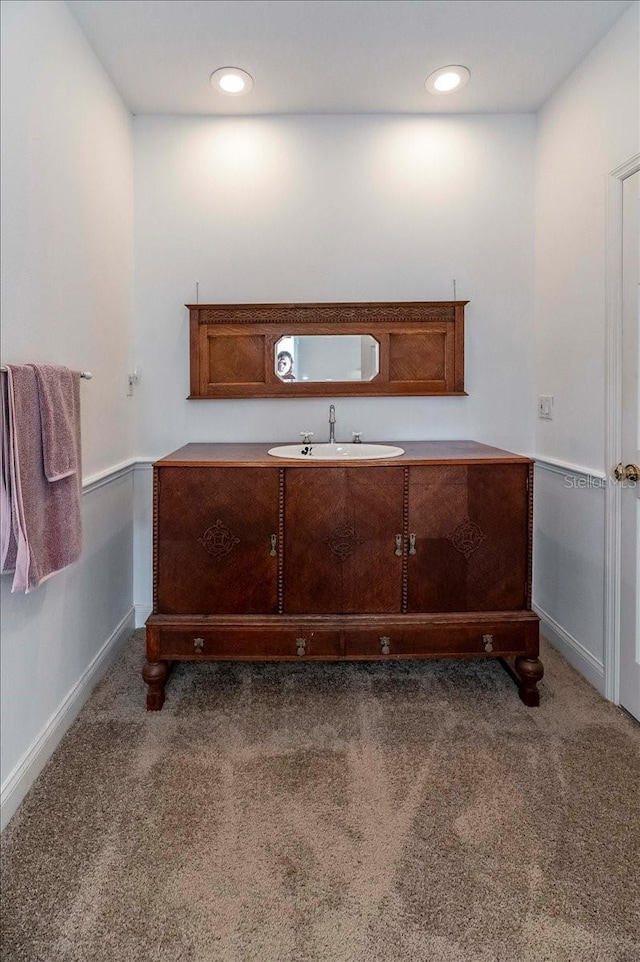 bathroom featuring recessed lighting, baseboards, and vanity