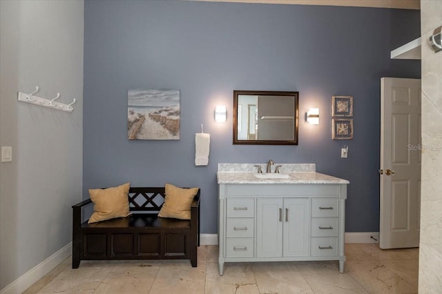 bathroom featuring marble finish floor, baseboards, and vanity