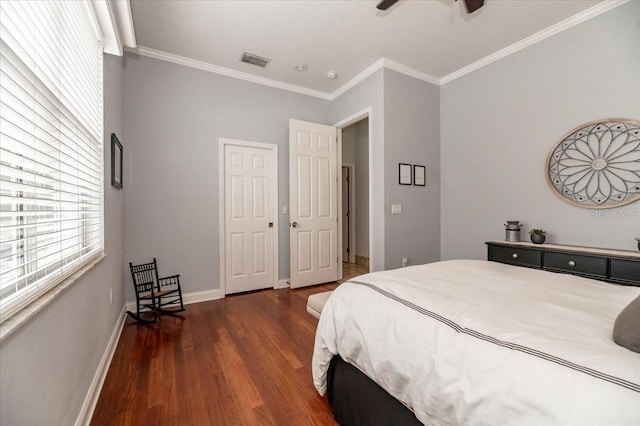 bedroom with visible vents, ornamental molding, a ceiling fan, wood finished floors, and baseboards